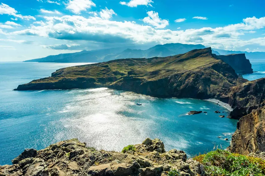 Headland and bay seen from above in bright sun