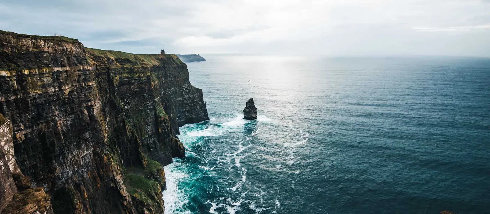 Tall sea cliffs with a sea stack