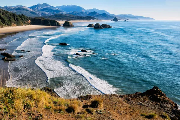 Rugged coastline with sea stacks and a long beach