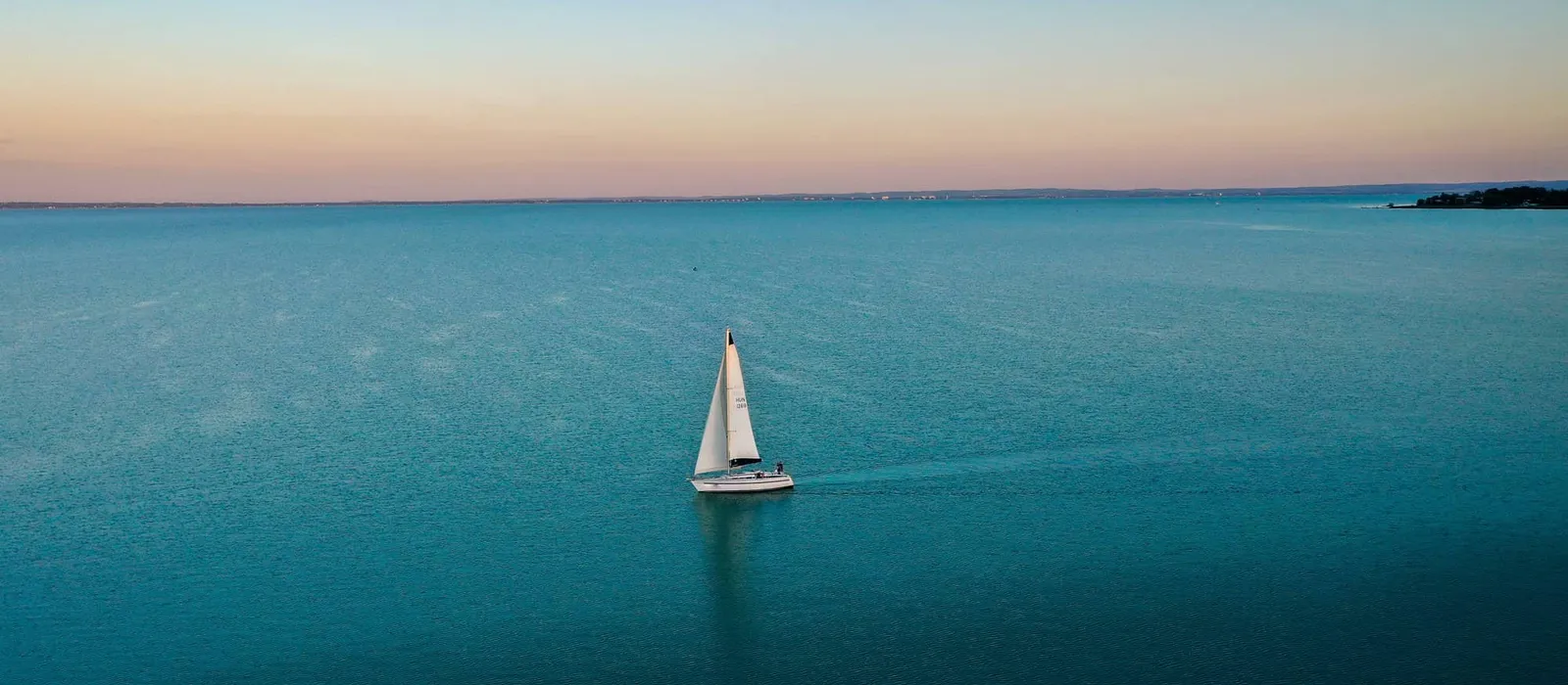 Sailboat on calm water at dusk