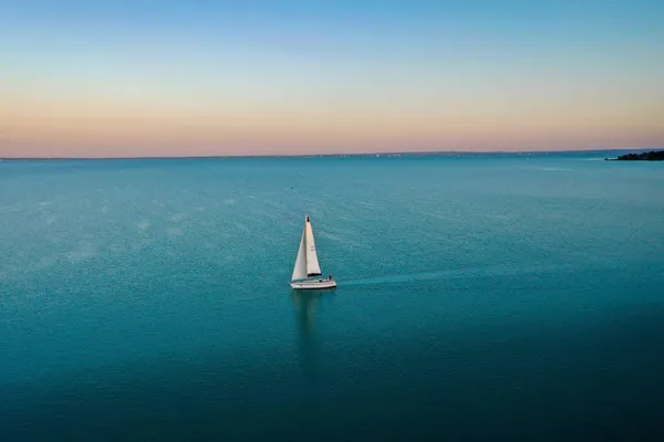 Sailboat on calm water at dusk