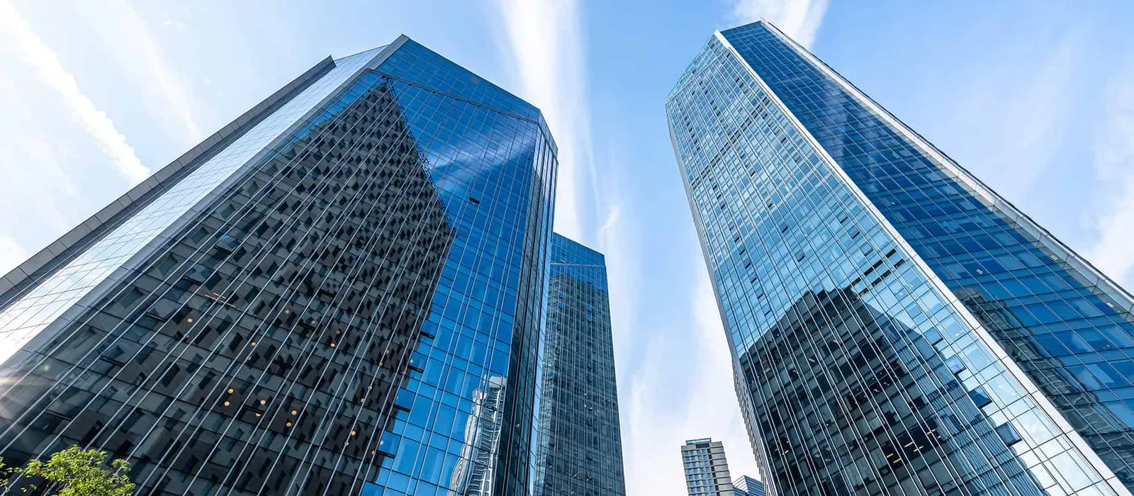 Glass office towers against a blue sky